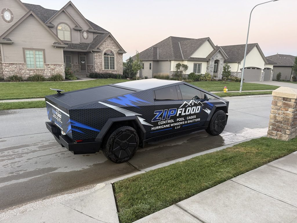 Wrapped Zip Flood Control Cybertruck parked in a residential driveway